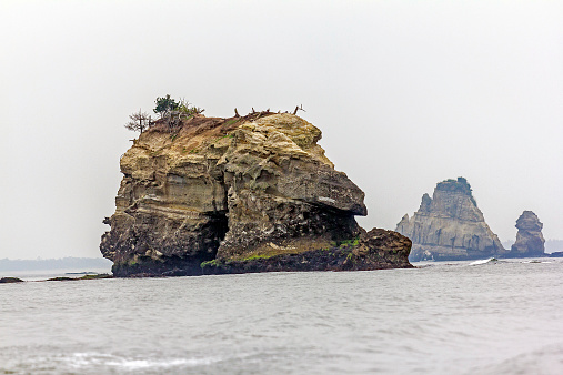 rockc protruding from the misty sea at matsushima, Japan