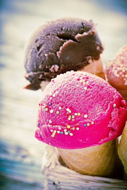 istock Ice cream scoops on wooden table. 533629245