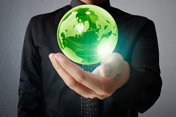 istock holding a glowing earth globe in his hands 533629671