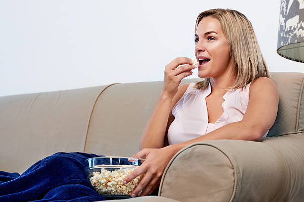 istock Woman eating popcorn 533631141