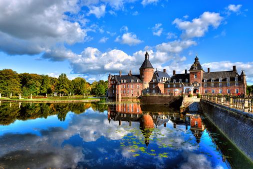 Munsterland, Germany - October 7, 2012: The Anholt Castle is a beautiful 12th century moated castle that sits quietly on a lake as the trees begin to change to fall colors.  This water castle and hotel is located in western Munsterland of North-Rhine Westphalia, Germany.