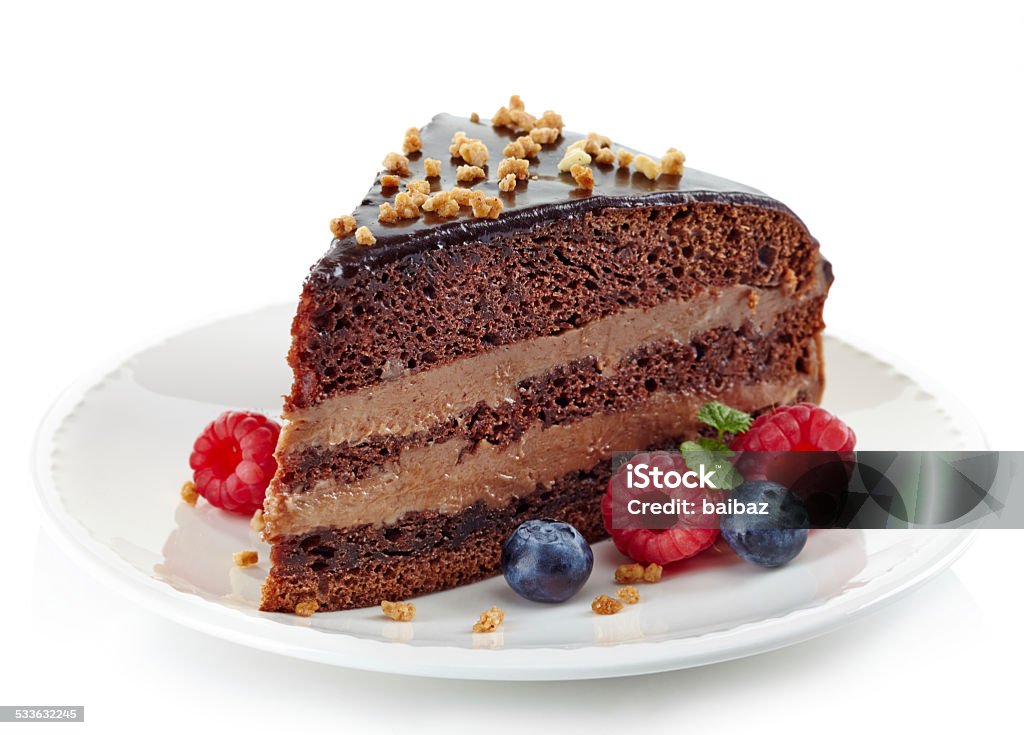 Chocolate cake Piece of homemade chocolate cake and fresh berries isolated on white background Slice of Cake Stock Photo