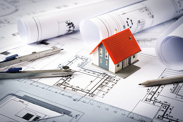 istock Housing Project - house model on blueprint for engineer drawing 533648149