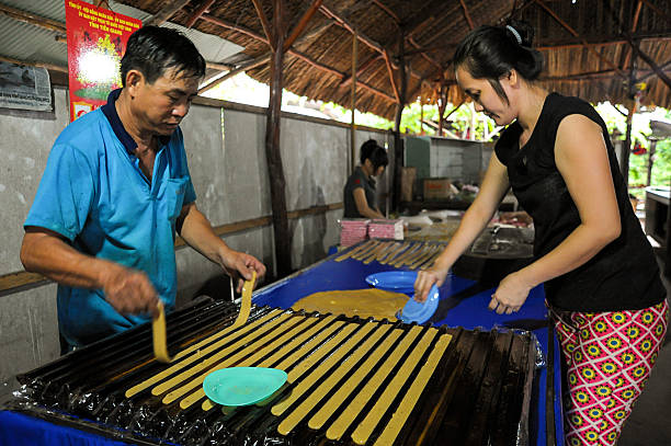 Making coconut candy in Vietnam stock photo