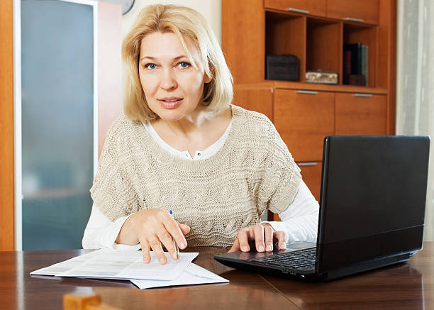 istock woman with laptop and financial documents in office 533650189