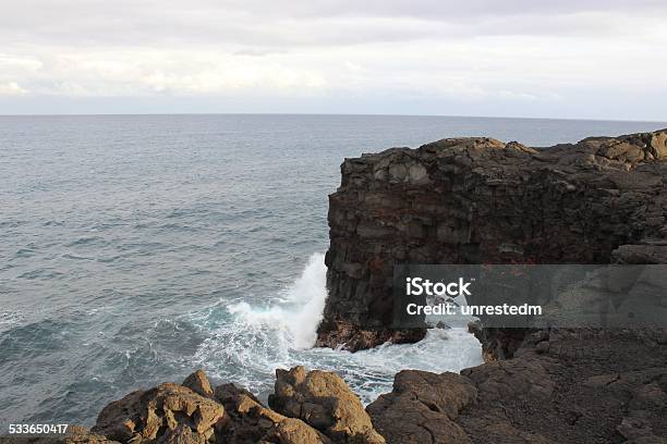 Natural Rock Arch On The Hawaiian Coast Stock Photo - Download Image Now - Coastline, Eroded, Flowing