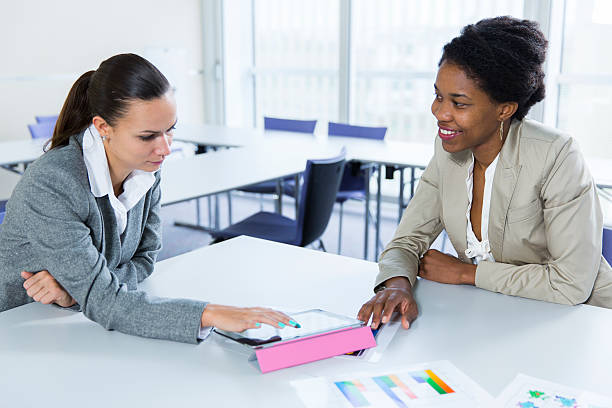 istock Business meeting..two women checking data on digital tablet 533665451