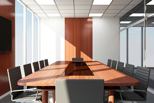 Large group of office chairs and conference table in meeting room.