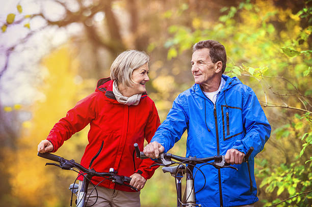 istock Active seniors walking with bike 533669985