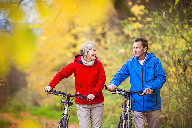 istock Active seniors walking with bike 533670003