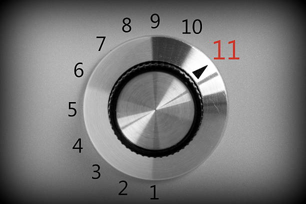 Full Power Black and white image of a volume or power control switch on a metal background that goes all the way up to the number eleven. knob photos stock pictures, royalty-free photos & images