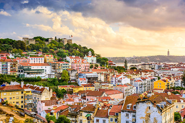 Lisbon, Portugal Skyline and Castle Lisbon, Portugal skyline at Sao Jorge Castle at dusk. baixa stock pictures, royalty-free photos & images