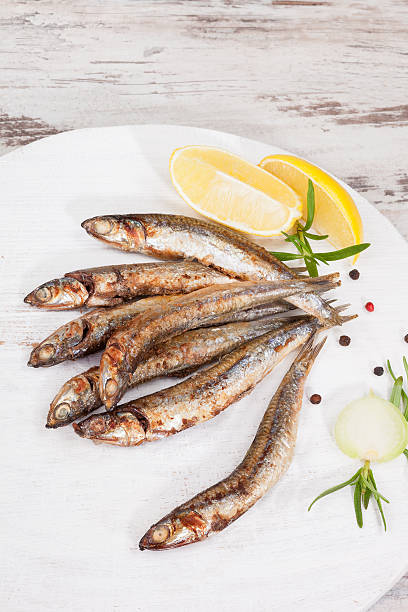 istock Grilled sardines on wooden background. 533696991