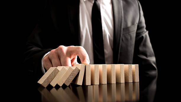 istock Businessman Stopping the Domino Effect 533697065