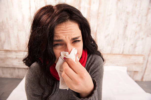 istock Frustrated woman blowing her nose 533697195
