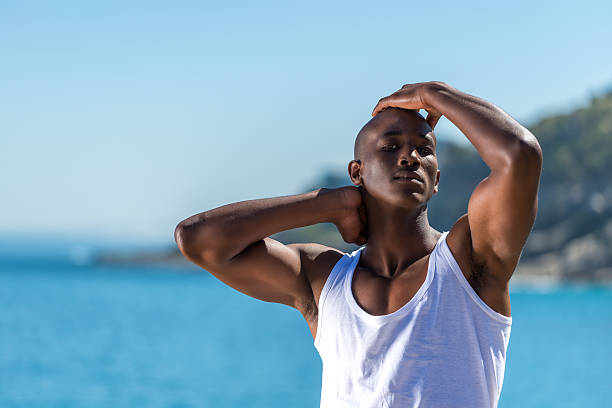 istock African black man wearing white vest and blue short jeans. 533697747