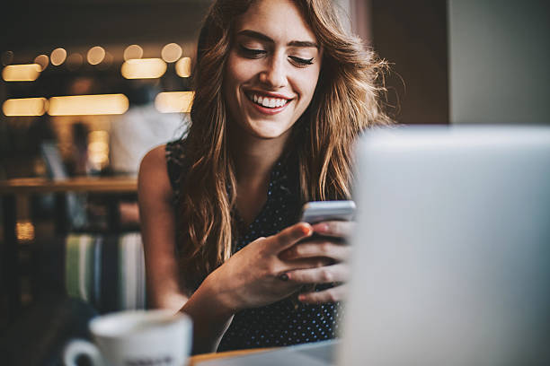 istock Young woman texting in coffee shop 533698346