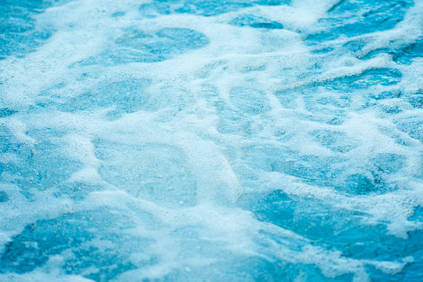 Blue clear fresh Water in hot tub. Spa massage background.
