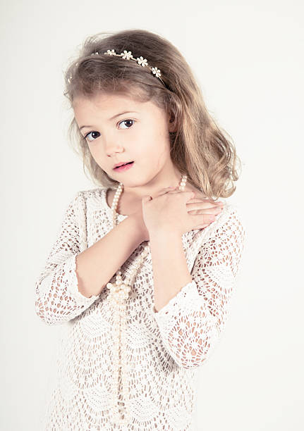 pensive hispanic or middle eastern little girl looking away