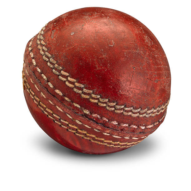 istock Old worn cricket ball on white 533703346