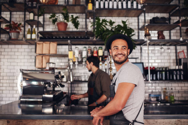 istock Coffee shop owner with barista working in behind 533705436