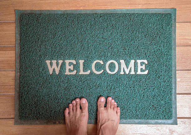 istock Barefoot standing on foot scraper with welcome word 533706234