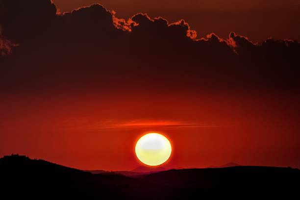 istock red sunset with sun and silhouette 533707702