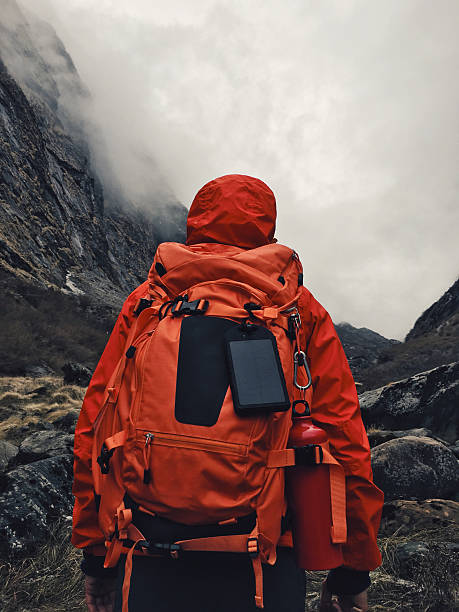 Hiker Photo of a hiker crossing the road fully equipped with a backpack / Photographed with iPhone 6s annapurna range photos stock pictures, royalty-free photos & images