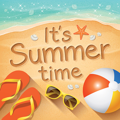 Summer Background with beach summer accessories and text written in the sand “It’s Summer time”