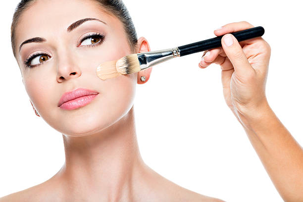 istock Makeup artist applying liquid tonal foundation  on the face 533712818