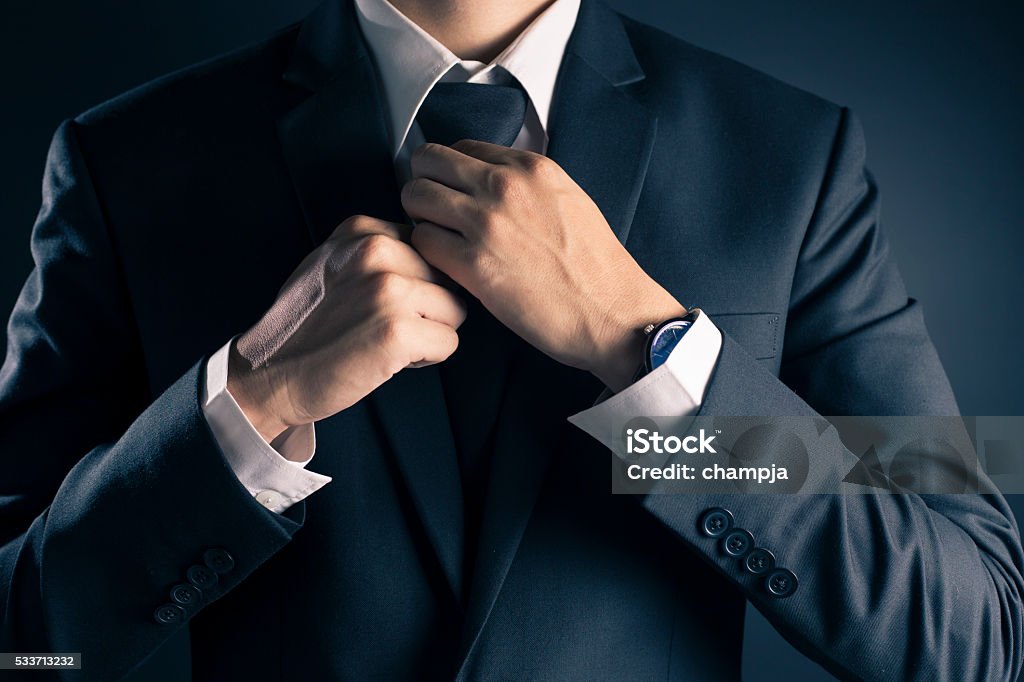 Empresario ajustar corbata su traje - Foto de stock de Anudar libre de derechos