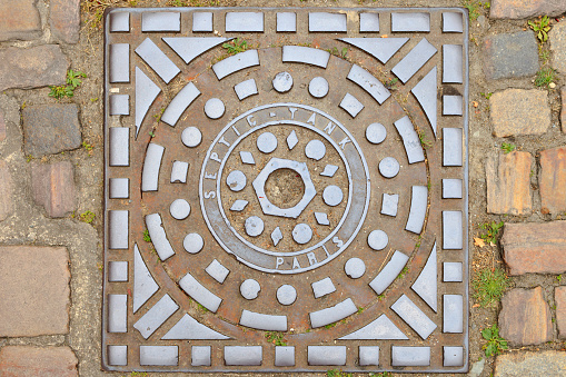 steel manhole cover, a removable plate forming the lid over the opening of a manhole, from Paris