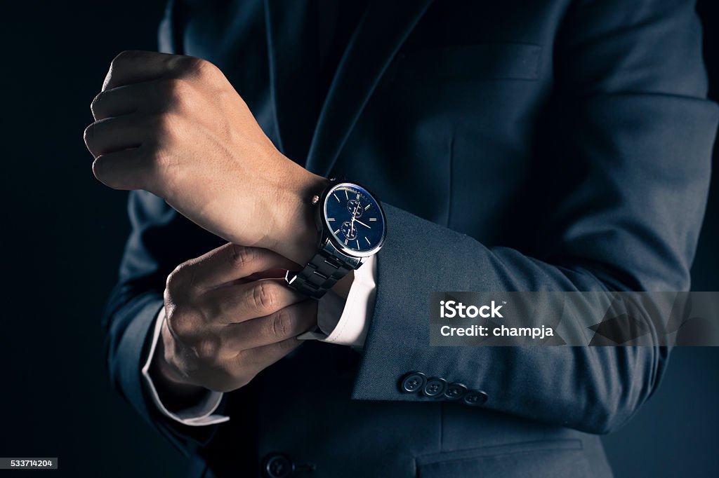 Businessman checking time from watch Watch - Timepiece Stock Photo