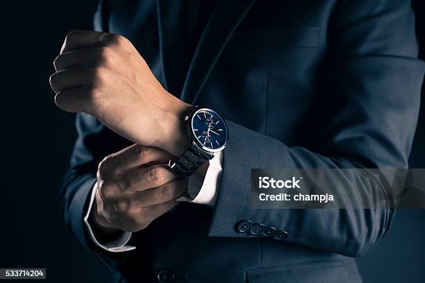 Businessman Checking Time From Watch Stock Photo - Download Image Now - Watch - Timepiece, Watching, Men