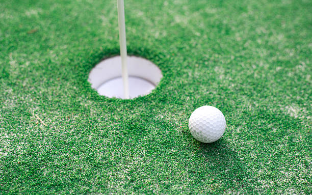 istock golf ball on lip of cup 533714228