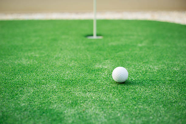 istock golf ball close to the hole 533714254