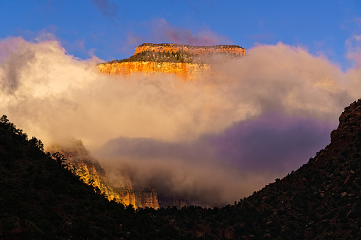 Zion Canyon with Low Hanging Clouds Dramatic Landscape - Sunrise with red rock canyon walls desert scenery.