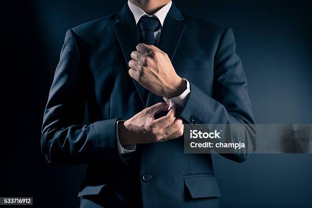 Businessman Fixing Cufflinks His Suit Stock Photo - Download Image Now - Suit, Men, Luxury