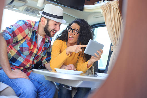 istock Smiling couple using digital tablet inside of a camper 533717380