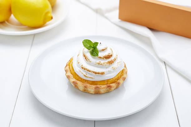 Lemon tart with whipped cream and mint sweet dessert stock photo