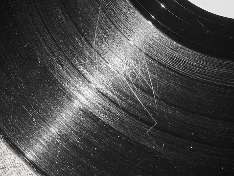 Badly damaged scratched vinyl record vintage analog music recording medium