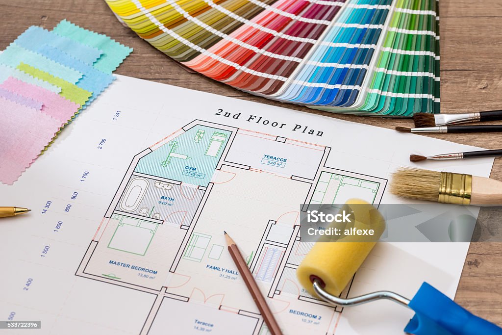 architectural drawings with color guide, paint roller, brushes, pencil Apartment Stock Photo