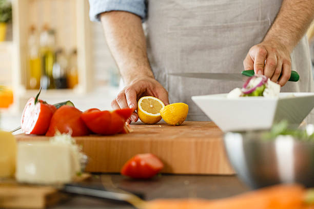 istock Man preparing lemon dressing for vegetables salad 533722624