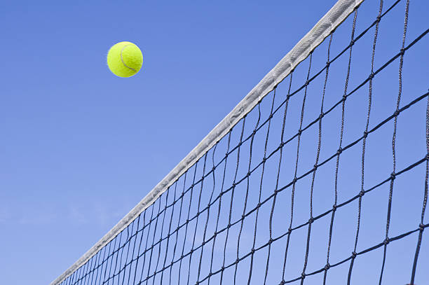 istock Yellow Tennis Ball Flying Over the Net 533722681