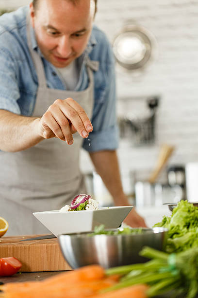 istock Man seasoning salad 533722890