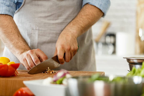 istock Man preparing healthy vegetables salad, cutting almond 533722922