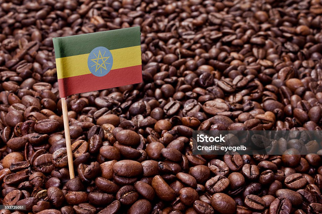 Flag of Ethiopia sticking in coffee beans.(series) The flag of Ethiopia sticking in roasted coffee beans.(series) Ethiopia Stock Photo