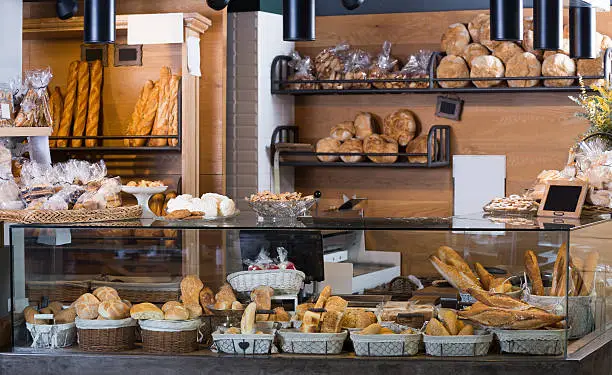 Buns, baguettes and other fresh bread at bakery display
