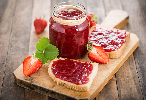 Strawberry jam on the bread stock photo