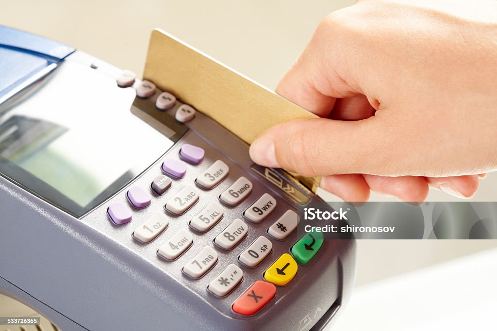 Paying by card Close-up of payment machine while human hand keeping plastic card in it 2015 Stock Photo